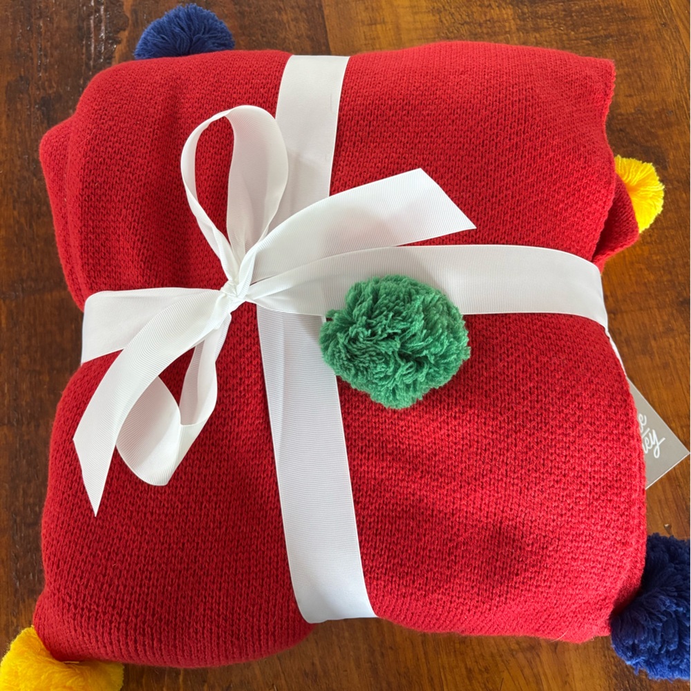 NWT Super cozy and cute Pom Pom blanket. 
50 inches by 60 inches